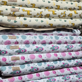a stack of folded fabrics, likely cotton